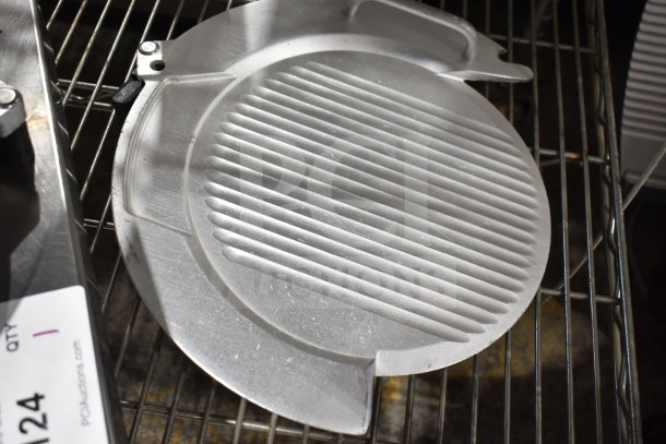 Metal meat slicer plate with grooves, shown on a wire rack. Slight wear visible. Auction tag reads "qty 1, lot 124."