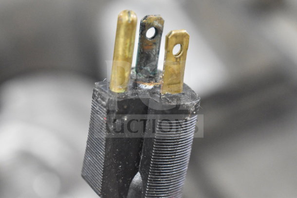 Close-up of a three-prong plug on a Bizerba SE 12 D US commercial meat slicer, showing signs of wear and corrosion.