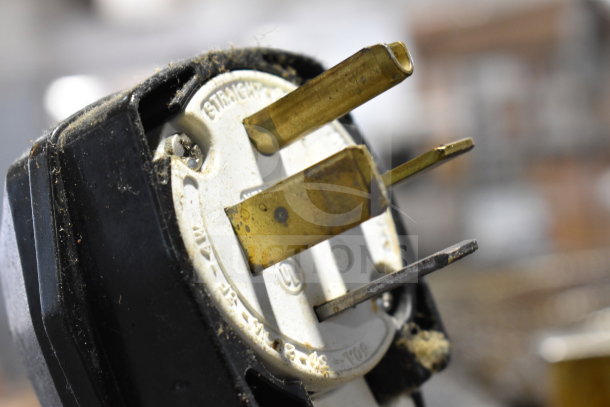 Close-up of a plug for a Turbochef HhC2020 commercial oven, showing metal prongs and dust accumulation.