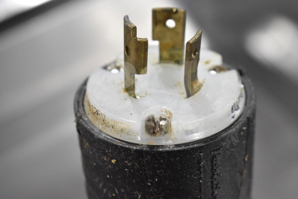 Close-up of a power plug from a True TPP-67 Commercial Pizza Prep Table. Plug shows some wear, marked "125V".