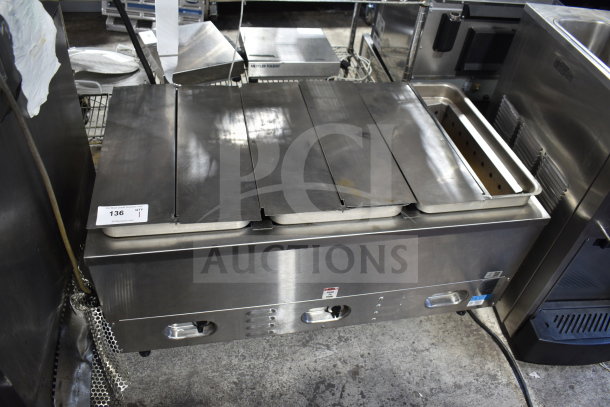 Countertop 3 well steam table with stainless steel finish, three lids, and manual controls, great condition, auction tag visible.