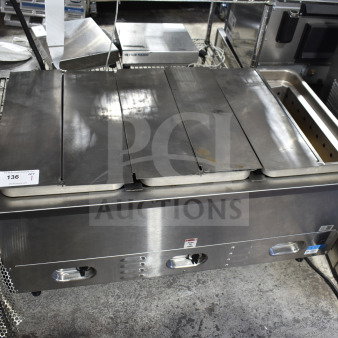 Countertop 3 well steam table with stainless steel finish, three lids, and manual controls, great condition, auction tag visible.
