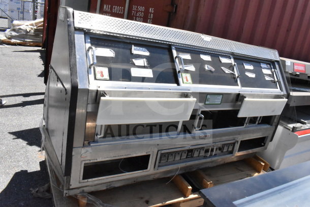 Commercial floor-style warming display case merchandiser with glass doors and metal frame, showing control panel and air vents.