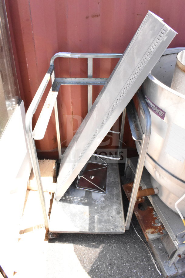 Commercial baking pan rack with multiple shelves on sturdy commercial casters, metal frame, good condition, outdoors.