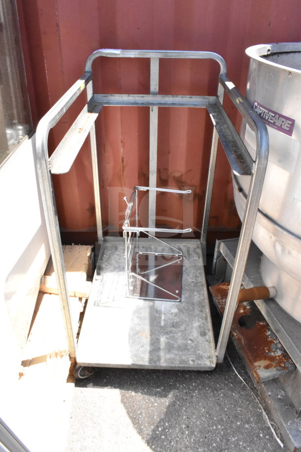 Commercial baking pan rack with metal frame on commercial casters, shows signs of wear, ideal for bakery use.