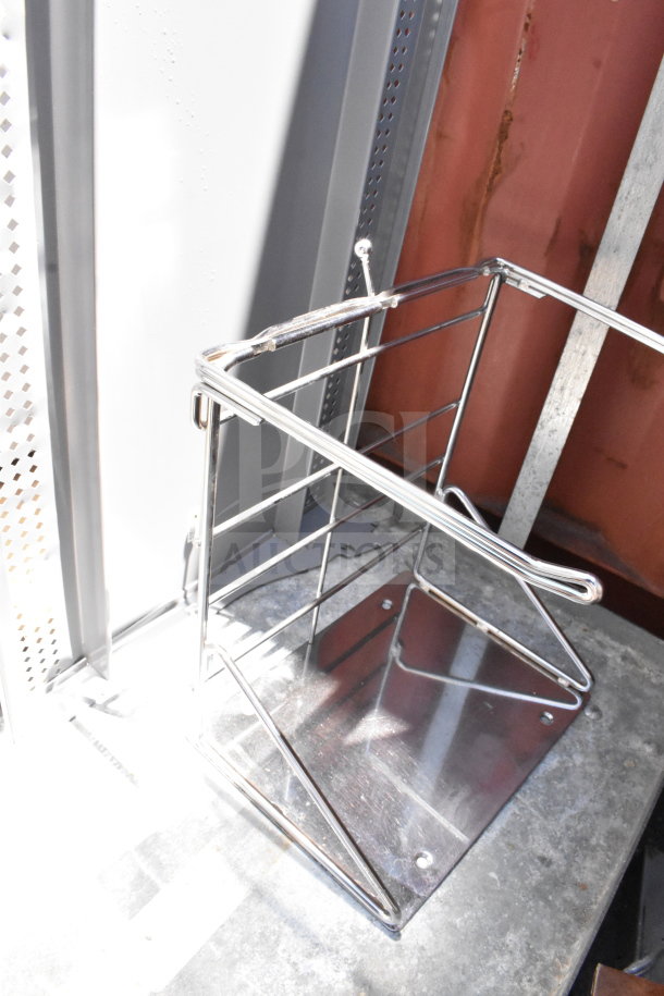 Commercial baking pan rack with shiny metal frame on commercial casters. Sturdy construction and ideal for bakery use.