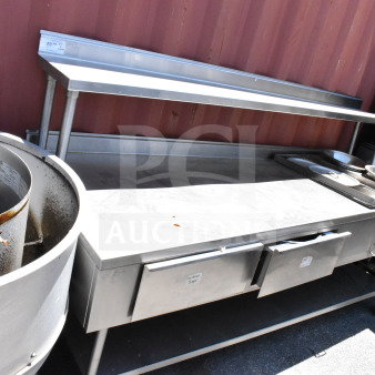 Commercial table with two drawers, upper shelf, lower shelf, and heated well, stainless steel, used condition.