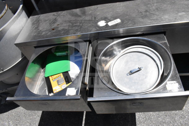 Commercial table with two drawers, over and under shelves, heated well, stainless steel construction, some surface marks.