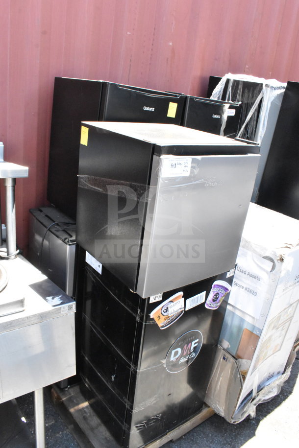 Seven mini coolers, including Galanz and Hisense brands, 115 volts, 1 phase; exterior labels include brand markings.