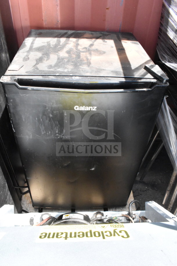Black Galanz mini cooler, 115 volts, 1 phase, shows surface wear. Includes 6 coolers total. Auction item.