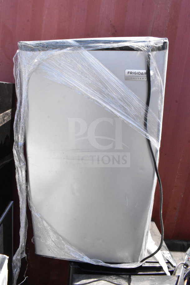 6 mini coolers including Galanz and Insignia models, 115 volts, 1 phase. Frigidaire cooler shown, wrapped in plastic for auction.