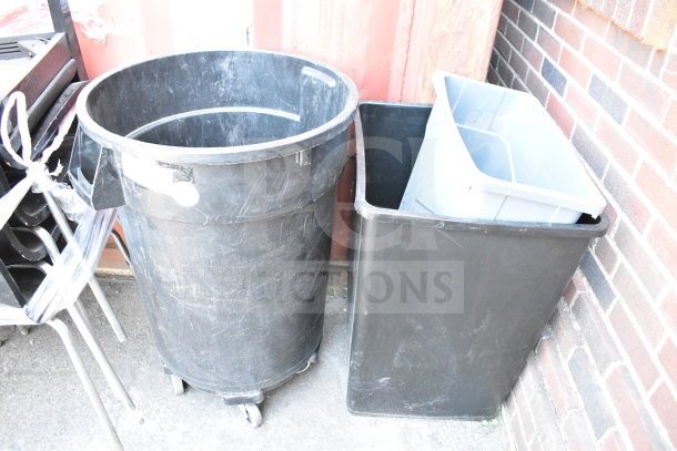 Three black and gray trash cans, various sizes, used condition. One with wheels. Industrial settings. Auction item: 3 times bid.