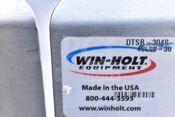 Winholt commercial table, model DTSB-3048, with back splash and under shelf. Made in USA. Visible label with contact info.