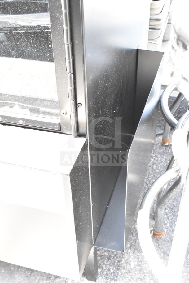 Commercial dry bakery bagel pastry display case, black metal frame, glass panels, in used condition, showing hinges.