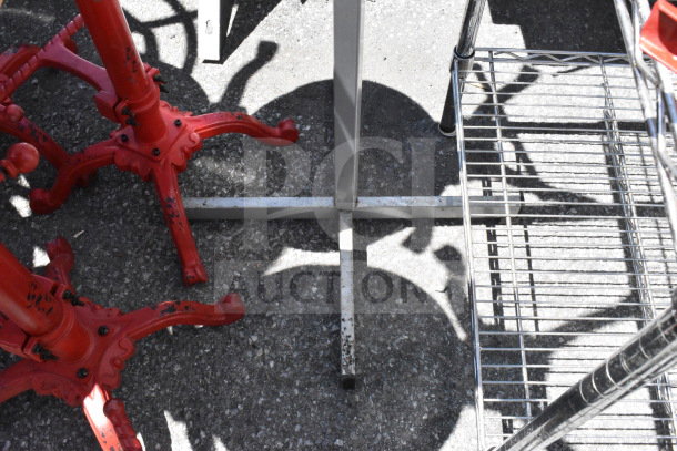 Metal coat rack base shown, with red cast iron claw-foot legs, some paint wear visible, sturdy construction.