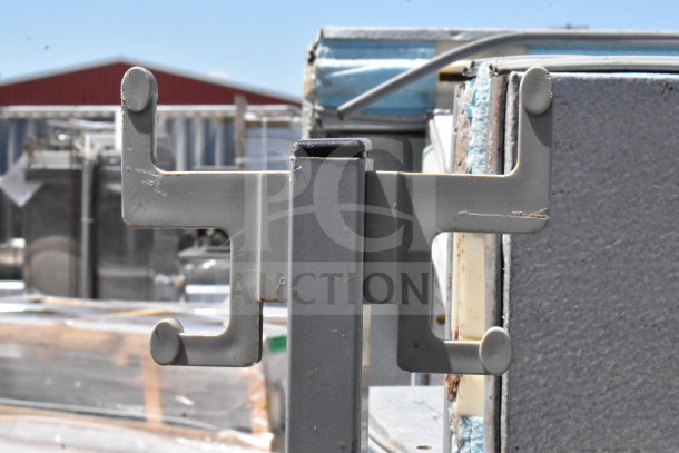 Gray metal coat rack with multiple hooks, showing minor surface wear. Ideal for both home and office use.