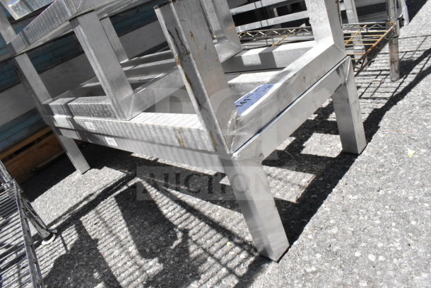 5 various metal dunnage racks in used condition, showing slight wear and visible labels, sold as a lot.