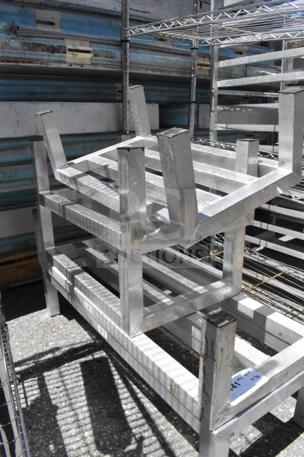 5 aluminum dunnage racks, stacked, in used condition. Durable construction, suitable for heavy-duty storage.