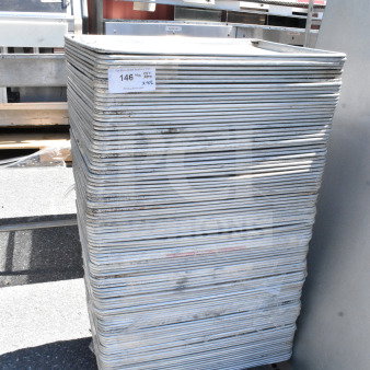 Stack of 102 full-size baking pans, silver, used condition. Auction tag reads "Lot 146, QTY 102." Ideal for bulk purchase.