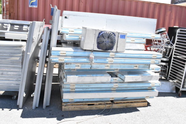 Arctic Walk In Box with Bohn evaporator fan, shown disassembled. Includes insulated panels and metal doors. Used condition.