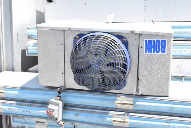 Arctic Walk In Box with Bohn evaporator fan, metal casing, blue grille, signage, used condition, visible wiring.