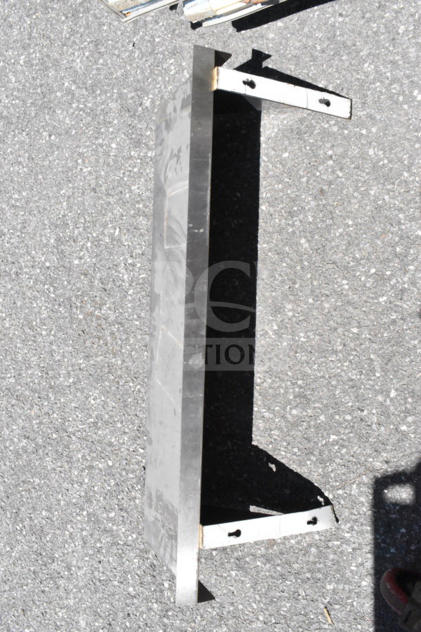 Metal wall mount shelf with two side brackets, visible wear, suitable for storage or display.