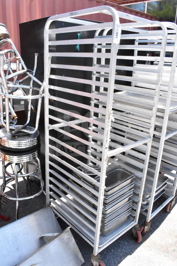 Commercial pan transport rack on casters with 30 drop-in bins. Sturdy metal construction, ideal for kitchen storage.
