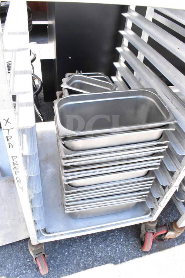Commercial pan transport rack on casters with 30 drop-in bins, sturdy metal construction, partially filled; label reads "XTRA PREP RY."