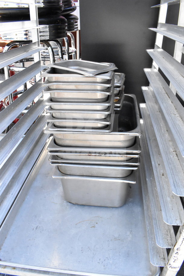 Commercial pan transport rack, metal with shelves, on casters, includes 30 metal drop-in bins. Used condition, sturdy build.