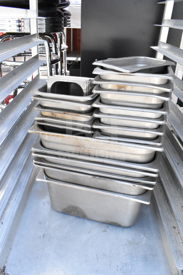 Commercial pan transport rack with casters, containing 30 stainless steel drop-in bins. Some bins show wear.