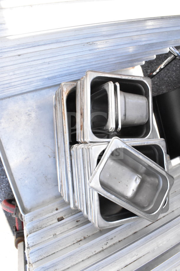 Commercial pan transport rack on casters, includes 30 drop-in bins, metal construction. Good condition, some wear.