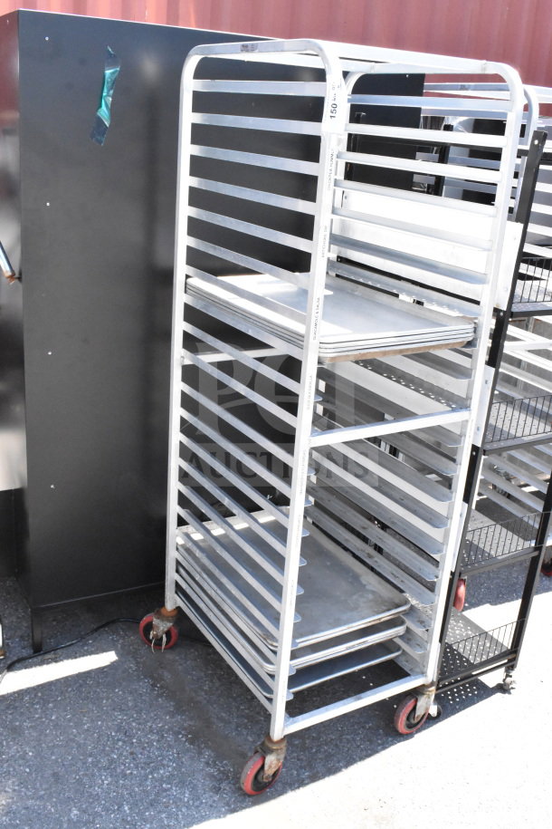 Commercial pan transport rack on casters with 10 baking pans, metal construction, showing minor wear.