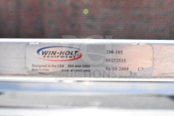 Commercial pan transport rack by Win-Holt, includes 10 baking pans and features commercial casters. Label: Model 200-105.