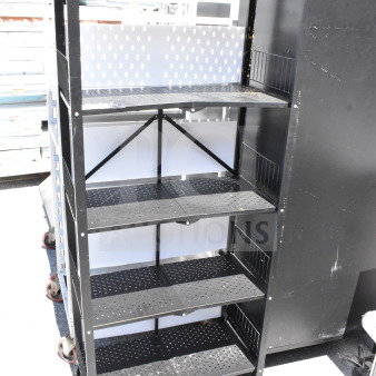 Black shelving unit with five perforated shelves on commercial casters, showing signs of light wear. Rugged construction.