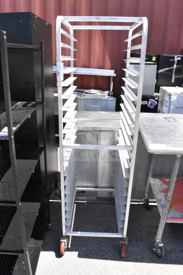Commercial pan transport rack with multiple shelves, mounted on durable commercial casters for easy mobility.