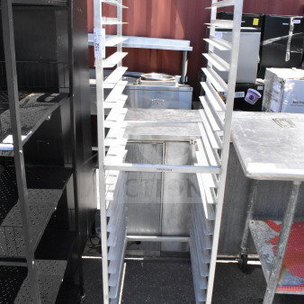 Commercial pan transport rack with multiple shelves, mounted on durable commercial casters for easy mobility.