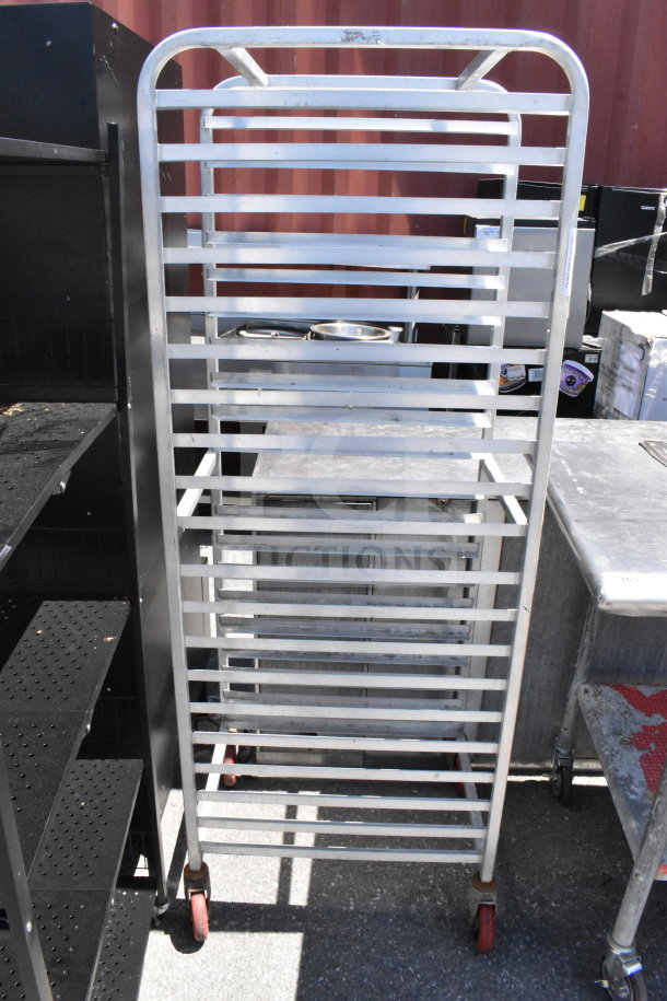 Commercial pan transport rack with multiple shelves, on swivel casters. Sturdy metal construction, ideal for kitchen use.
