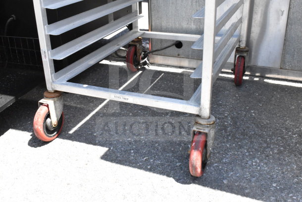 Commercial pan transport rack with multiple shelves on red commercial casters, labeled "XTRA PREP."