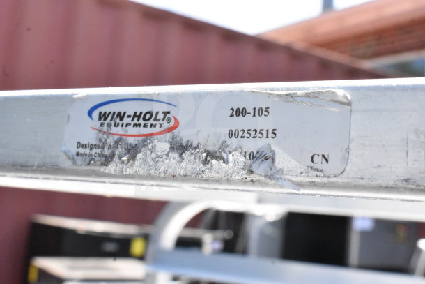 Win-Holt commercial pan transport rack, model 200-105. Features visible wear and markings. Includes label with model info.