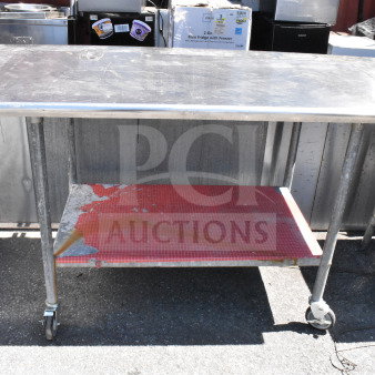 Commercial table with under shelf, mounted can opener, on commercial casters. Shows moderate wear, suitable for kitchen use.