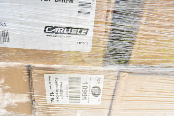 Shrink-wrapped boxes labeled with "Carlisle" and "PerfectGrip Tomato Stem Corer," indicating new kitchen items for auction.