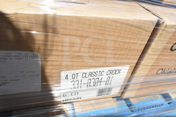 Cardboard box labeled "4 QT Classic Crock, 331-0304-01, 6 EA, Brown," wrapped in plastic, stacked on a pallet.