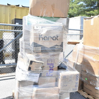 Pallet of 30 brand new scratch and dent items, including shot glasses, plates, towels. Visible labels: Karat, FedEx, Tork.