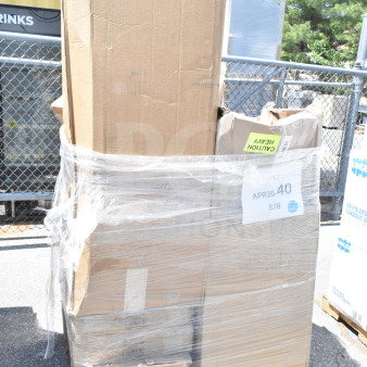 Pallet with 13 brand new, scratch and dent items wrapped in plastic. Visible label reads "APR26-40 876," marked "Caution Heavy."