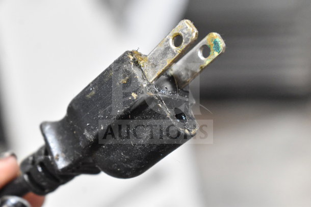Close-up of a worn electrical plug with minor corrosion, part of a 2017 Hobart HTi-7LH26 food portioning scale.