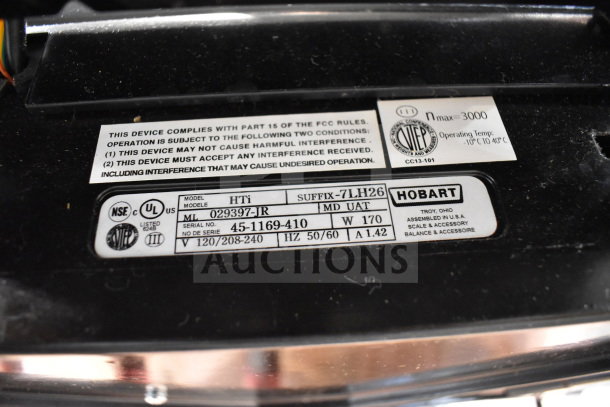 2017 Hobart HTi-7LH26 commercial food portioning scale label, displaying model, serial number, voltage, and certification marks.