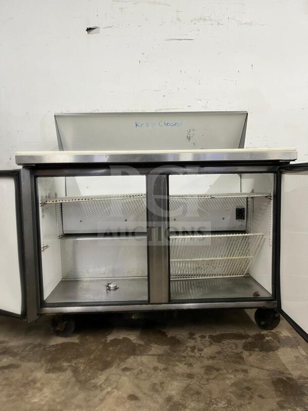 True TSSU-48-12-HC stainless sandwich prep unit, 12 cu ft, holds 12 1/6 pans, fair condition, visible wear, "Keep Closed" label.