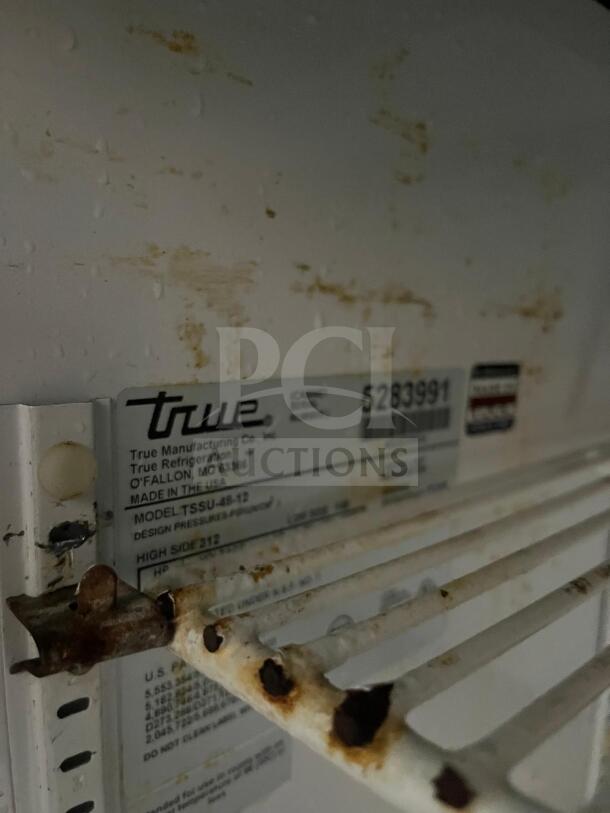 True TSSU-48-12-HC stainless prep unit label, showing rust and wear. Holds 12 1/6 pans. Model details visible.