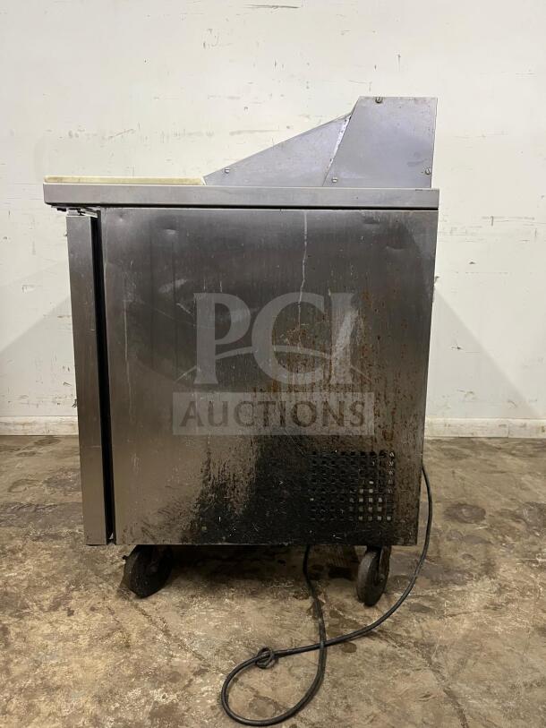 True TSSU-48-12-HC stainless salad prep unit, holds twelve 1/6 pans, visible wear and rust, on wheels, includes power cord.
