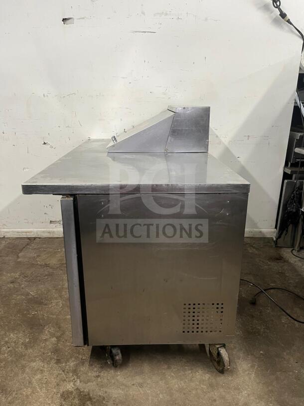 True TSSU-60-12M-B-HC refrigerated prep table, stainless steel, 2 doors, 12 pans, on wheels, good condition.